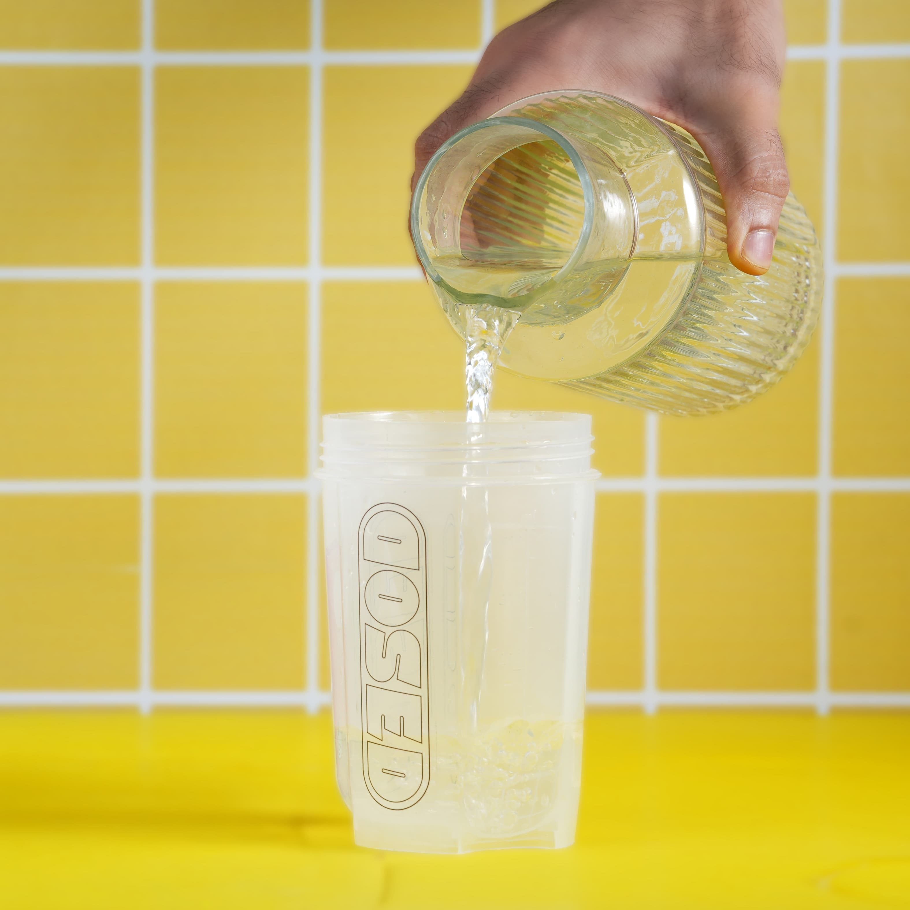 Cold water being poured into a DOSED shaker